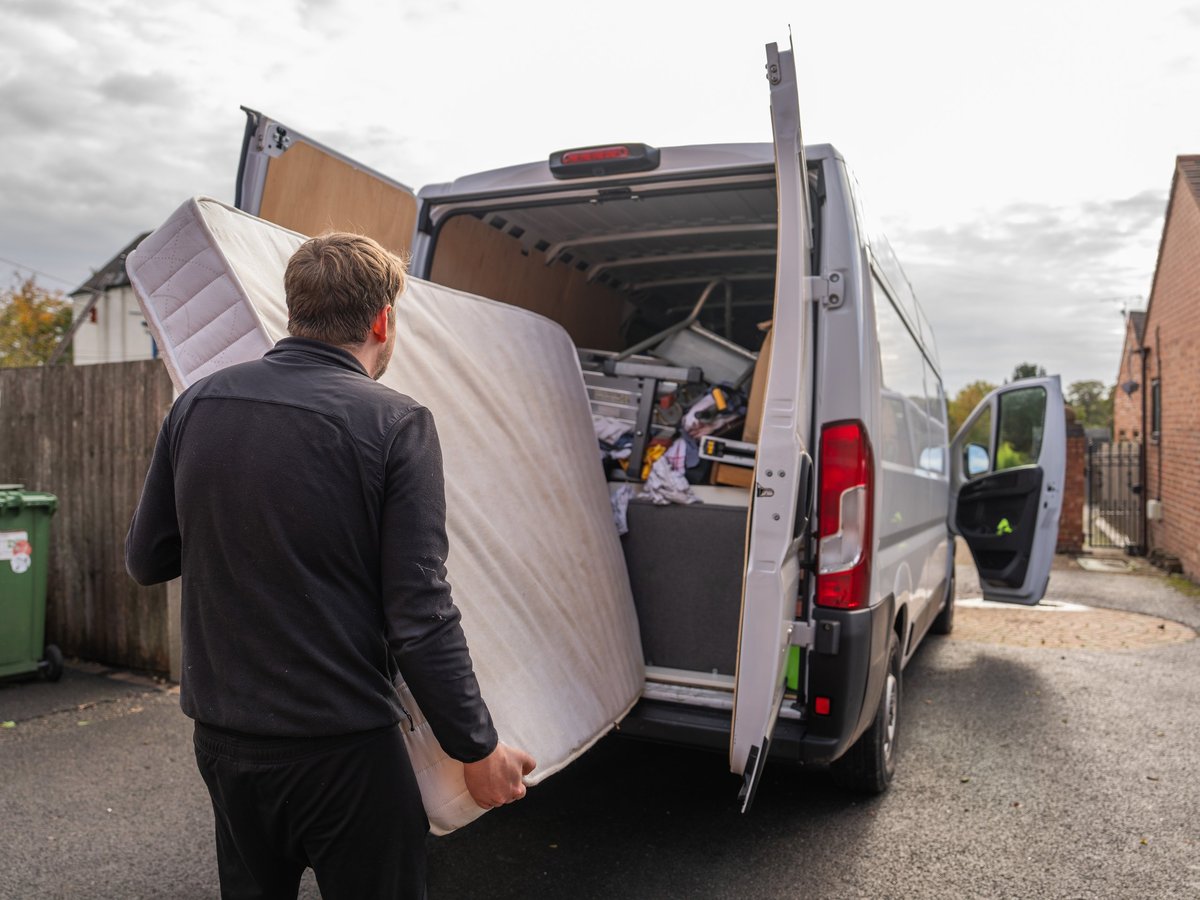 Mattress being loaded into a removal truck