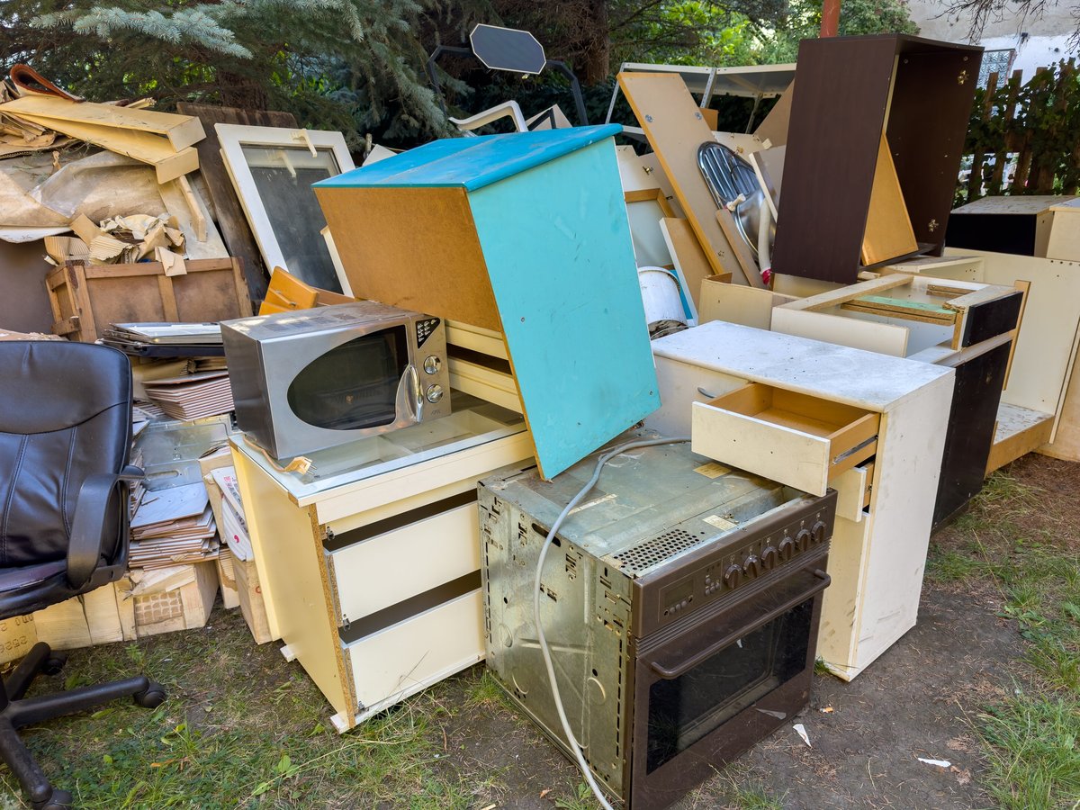 Old appliances and furniture staged for junk removal
